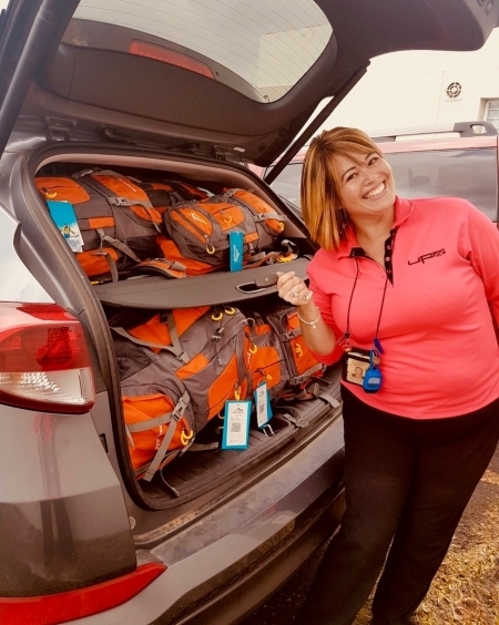 Photo: A car full the brim with supply backpacks