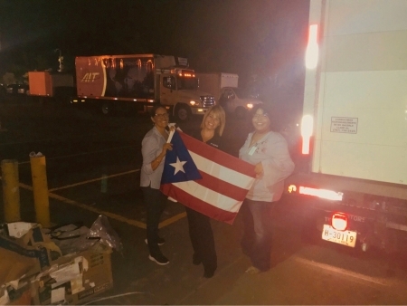 Photo: San Juan City Hospital staff at airport holding Puerto Rican flag