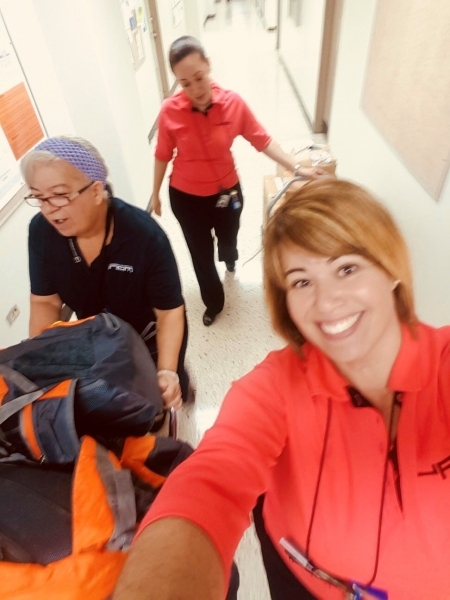 Photo: University of Puerto Rico staff transporting backpacks