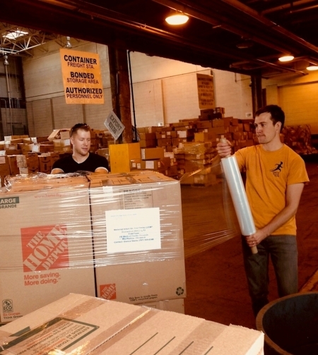Photo: Brad and Erik wrapping boxes